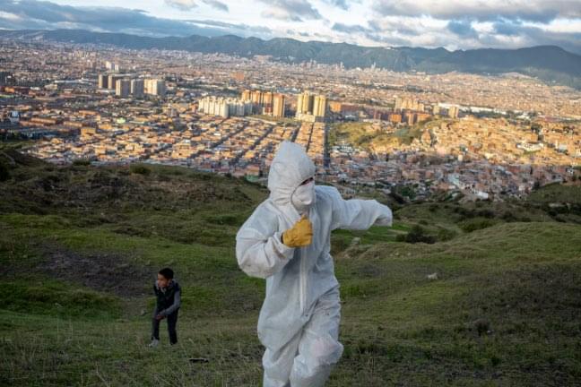 An activist of the "Blue Shields" (“Escudos Azules”) is playing with a child after spending the day with the slum dwellers of Los Altos de la Estancia.
    