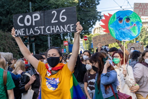 People with signs march in the street